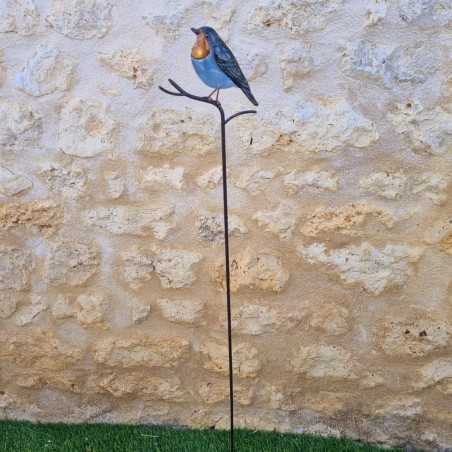 Decoratieve vogel op oranje prikker