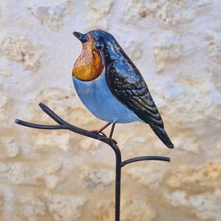 Decoratieve vogel op oranje prikker